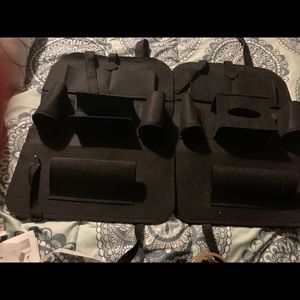 Black storage hanger for back seats in vehicle